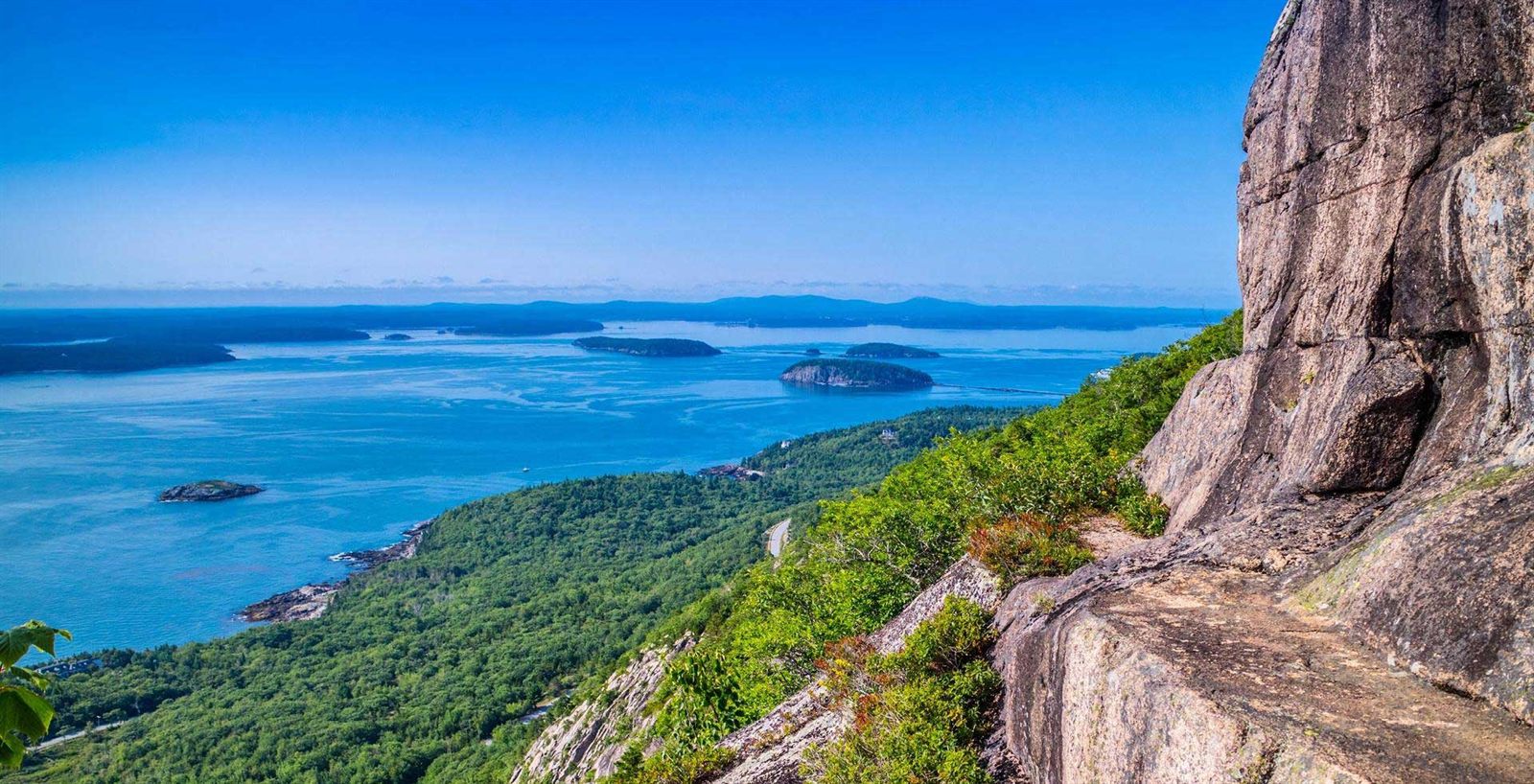 Green coastline and islands under a clear sky